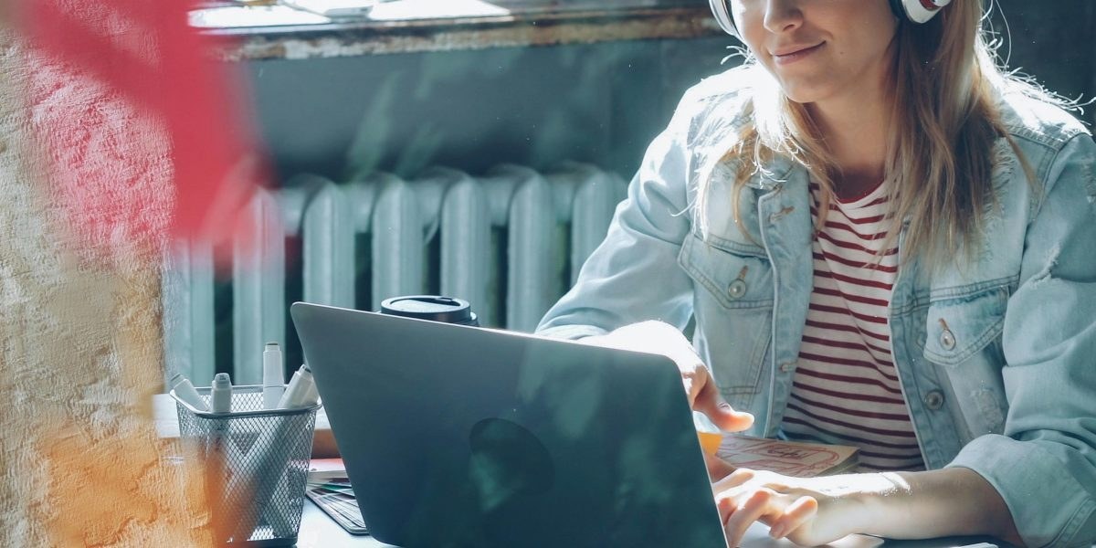 Remote sales professional working from home with headset and laptop