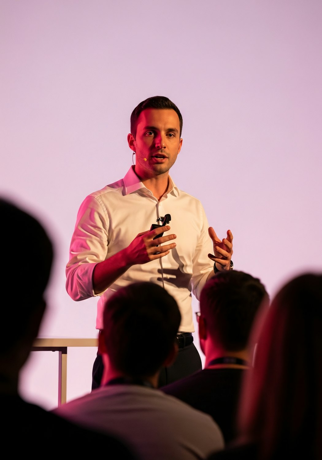 A person practicing a sales pitch or presentation, perhaps using notes or a mirror, representing the dedication required to develop strong objection handling and negotiation skills.